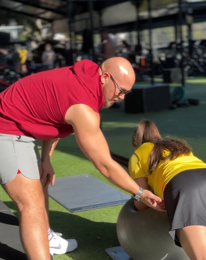 "Fitness trainer focusing on correct posture while doing core exercise."
