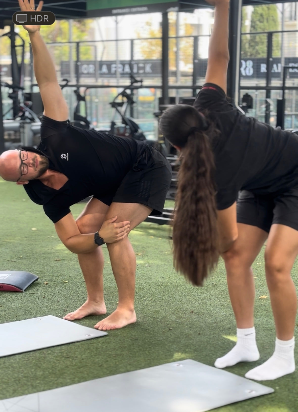 "Personal coach in Marbella guiding a client to a mobility drill."